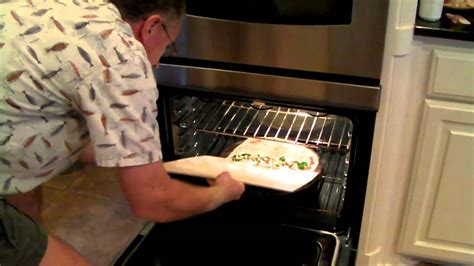 Transfer pizza - Learn an easy and reliable way to transfer a pizza to a stone without a peel. Transferring pizza into the oven has never been easier. For more information, c... 
